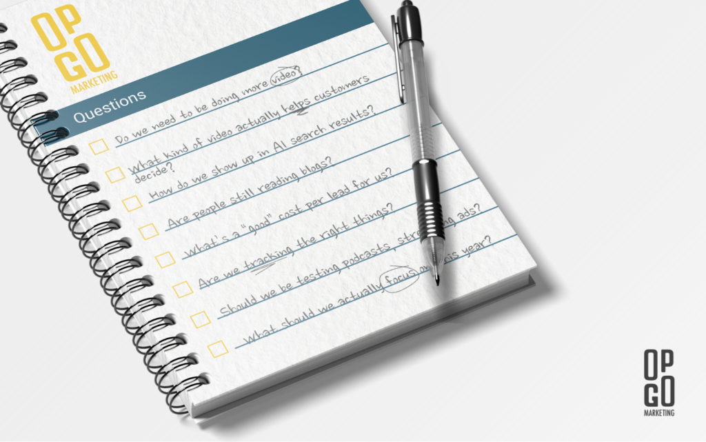 note book listing out common marketing questions